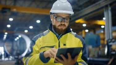 man using tablet to assess archive migration